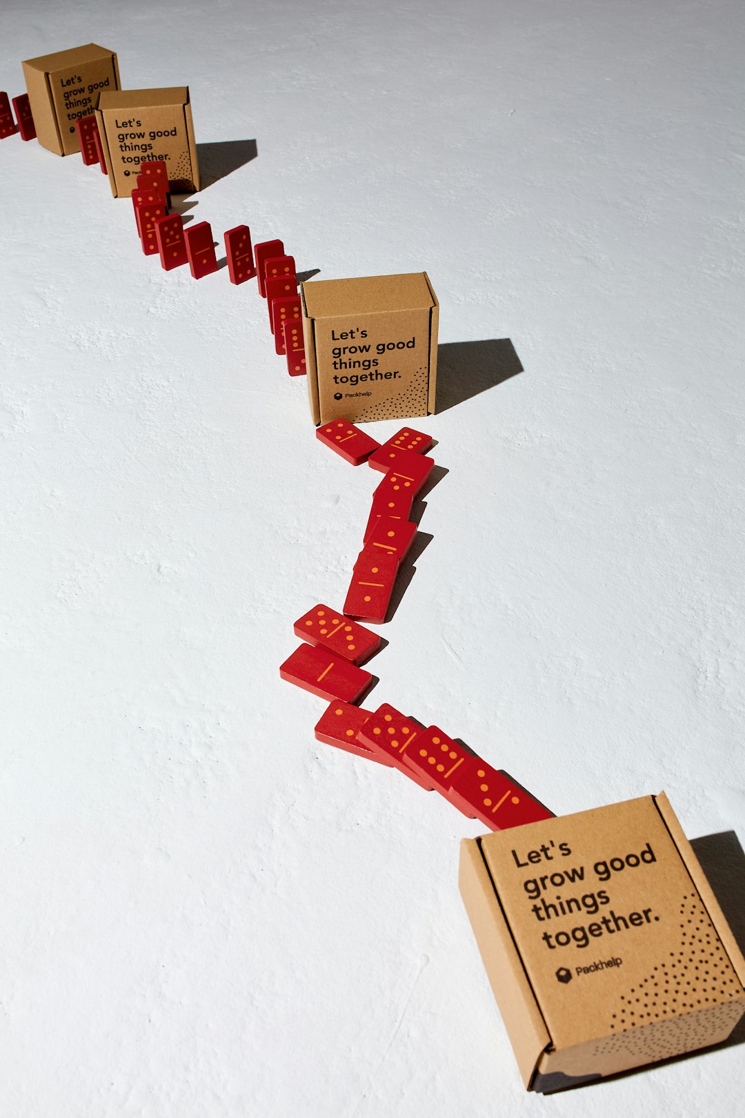 a-long-line-of-boxes-with-red-ribbons-attached-to-them-raxfqecbxum