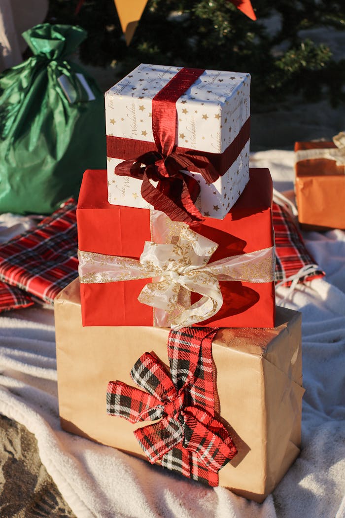Festively wrapped presents stacked with ribbons, perfect for holiday celebrations.